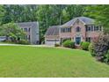 Traditional brick home with a large front yard and mature landscaping at 747 Mill Rock St, Lawrenceville, GA 30044