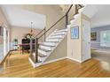 Modern staircase with wood treads, white risers, and cable railing, leading to the upper level of the home at 747 Mill Rock St, Lawrenceville, GA 30044