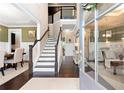 Bright foyer showcasing hardwood floors, a staircase with dark wood railings, and an open layout at 411 Ridgeway Ln, Canton, GA 30114