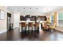 Modern kitchen with dark cabinetry, granite countertops, stainless steel appliances, and island seating at 411 Ridgeway Ln, Canton, GA 30114