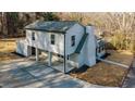 Inviting two-story home featuring light gray siding, brick chimney, and a spacious driveway, captured from an aerial perspective at 204 Elm St, Palmetto, GA 30268