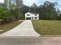 Lovely two-story home with a freshly poured concrete driveway and a large, manicured front lawn at 35 Yellow Brick Way, Covington, GA 30014