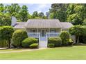 Charming single Gathering home featuring a landscaped yard, front porch with white stairs, and trimmed bushes at 6275 Cheatham Lake Nw Dr, Acworth, GA 30101