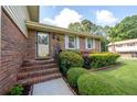 Home featuring a brick facade, complemented by lush landscaping and an inviting front entry at 4205 Jeri Lynn Ct, Tucker, GA 30084