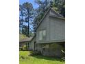 Unique two-story home with gray siding, modern architectural details, and well-maintained landscaping at 4287 Ridgetop Trl, Ellenwood, GA 30294