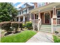 Inviting front porch with manicured lawn and beautiful landscaping at 1744 Habershal Nw Dr, Atlanta, GA 30318