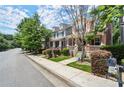 Serene neighborhood street view with townhomes and mature trees lining the sidewalks at 1744 Habershal Nw Dr, Atlanta, GA 30318