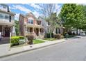 Street view of attractive townhomes with well-manicured lawns and sidewalks at 1744 Habershal Nw Dr, Atlanta, GA 30318