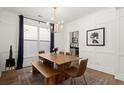 Bright dining room with a modern chandelier, stylish decor, and a view into the kitchen at 1744 Habershal Nw Rd, Atlanta, GA 30318