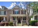 A well-maintained home with a cozy front porch, shutters and neatly trimmed bushes in a suburban neighborhood at 1744 Habershal Nw Rd, Atlanta, GA 30318