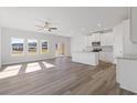 Bright living room features hardwood floors, recessed lights, and large windows at 940 Elwood St, Dacula, GA 30019