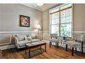 Cozy living room with hardwood floors, a seating area by a large window, and a decorative painting on the wall at 1249 Francis Nw St, Atlanta, GA 30318