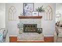 Cozy brick fireplace with a wooden mantle and decorative accents at 4458 Trickum Ne Rd, Marietta, GA 30066