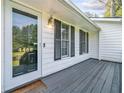 Inviting front porch with a gray wood deck, a glass front door and house number 4458 at 4458 Trickum Ne Rd, Marietta, GA 30066