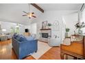 Bright living room with wood floors, vaulted ceiling, brick fireplace, and comfortable seating at 4458 Trickum Ne Rd, Marietta, GA 30066