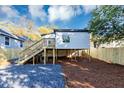 Features a wooden deck and stairs to a newly renovated backyard with gravel and mulched areas at 923 Smith Sw St, Atlanta, GA 30310