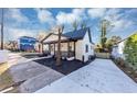 Charming home boasts a covered front porch with driveway, landscaping, and a tranquil neighborhood at 923 Smith Sw St, Atlanta, GA 30310