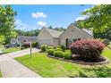 Beautiful home with manicured front lawn, complemented by vibrant shrubs, and a two car garage at 2125 Mina Lane Dr, Buford, GA 30518