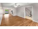 Spacious living room featuring hardwood floors and staircase leading to the upper level at 2340 Beaver Ruin Rd # 68, Norcross, GA 30071