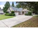 Traditional home with a long concrete driveway, complemented by green landscaping at 2835 Channing Way, Cumming, GA 30040