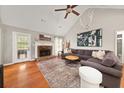 Cozy living area featuring a vaulted ceiling, stone fireplace, and neutral decor at 2835 Channing Way, Cumming, GA 30040