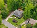 Spacious home in a lush setting, featuring a large yard and mature trees at 5107 Old Chestnut Ct, Woodstock, GA 30188