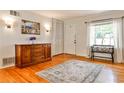 Bright foyer with hardwood floors, large window, classic dresser, and closet for extra storage at 1082 Greenbriar Cir, Decatur, GA 30033