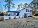 Charming two-story home with manicured lawn, decorative fence, and mature trees at 110 Randomwood Way, Alpharetta, GA 30022