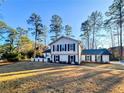 Charming two-story home with black shutters surrounded by lush greenery at 110 Randomwood Way, Alpharetta, GA 30022