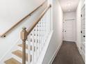 Bright hallway featuring wooden staircase with white banister and modern door frames at 1192 Wylie Se St # 429, Atlanta, GA 30316