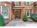 Inviting front entry with a brick facade, paver walkway, and decorative landscaping, creating a warm welcome at 5765 Riley Rd, Cumming, GA 30028