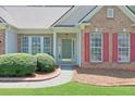 Close-up of the front door with neat landscaping and brick exterior at 935 Santa Anita Dr, Woodstock, GA 30189