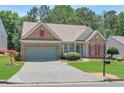 Lovely single-story house with attached garage, tidy lawn, and attractive landscaping details at 935 Santa Anita Dr, Woodstock, GA 30189