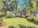 Charming single-story home with a brick facade and lush landscaping at 4639 Tell Sw Rd, Atlanta, GA 30331