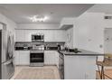 Modern kitchen with stainless steel appliances, granite countertops, and white cabinetry at 800 Peachtree Ne St # 101, Atlanta, GA 30308