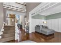 Bright, open-concept living space with hardwood floors, staircase and two-story entrance foyer at 1604 Summersweet Ln, Dacula, GA 30019