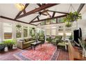 Bright sunroom with brick floors, vaulted ceilings, and lots of windows for natural light and hanging plants at 228 Clarion Ave, Decatur, GA 30030