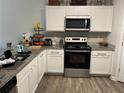 Well-lit kitchen features stainless appliances, granite countertops, and ample cabinet space at 30 Sloane Ct, Covington, GA 30016
