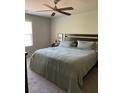 A well lit main bedroom with a ceiling fan and a comfortable looking queen sized bed at 30 Sloane Ct, Covington, GA 30016