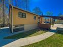 Side view of a home featuring a covered parking area and walkway at 3082 Dove Way, Decatur, GA 30033