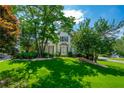 Beautiful home featuring a well-manicured lawn and mature trees at 1130 S Rudder Rd, Cumming, GA 30041