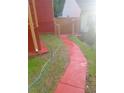 Narrow side yard features a red walkway and a tidy, grassy area at 1105 Oak Knoll Ter, Atlanta, GA 30315