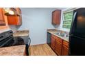 Functional kitchen featuring wooden cabinets, laminate countertops, and modern appliances at 2569 Dobbs Nw Dr, Kennesaw, GA 30152