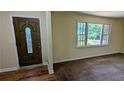 Bright living room with large window, neutral paint and new carpet at 3656 Salem Trl, Lithonia, GA 30038