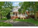 Beautiful brick home with a charming front porch and well-maintained landscaping at 4200 E Highway 166 Rd, Carrollton, GA 30116