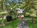 Classic brick home with a large front porch surrounded by mature trees at 4200 E Highway 166 Rd, Carrollton, GA 30116