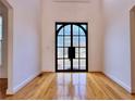 Foyer showcasing a statement steel and glass front door and hardwood floors at 6765 Crofton Dr, Alpharetta, GA 30005