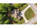 An aerial view shows an expansive yard, a patio area with outdoor seating, and a tree-lined property at 9742 Fallview Ct, Villa Rica, GA 30180