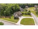 An aerial view of the neighborhood and the home's mature landscaping and expansive yard surrounded by verdant trees at 9742 Fallview Ct, Villa Rica, GA 30180