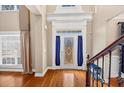 Elegant foyer featuring hardwood floors and beautiful front door with side windows at 101 Lumby Ln, Stockbridge, GA 30281